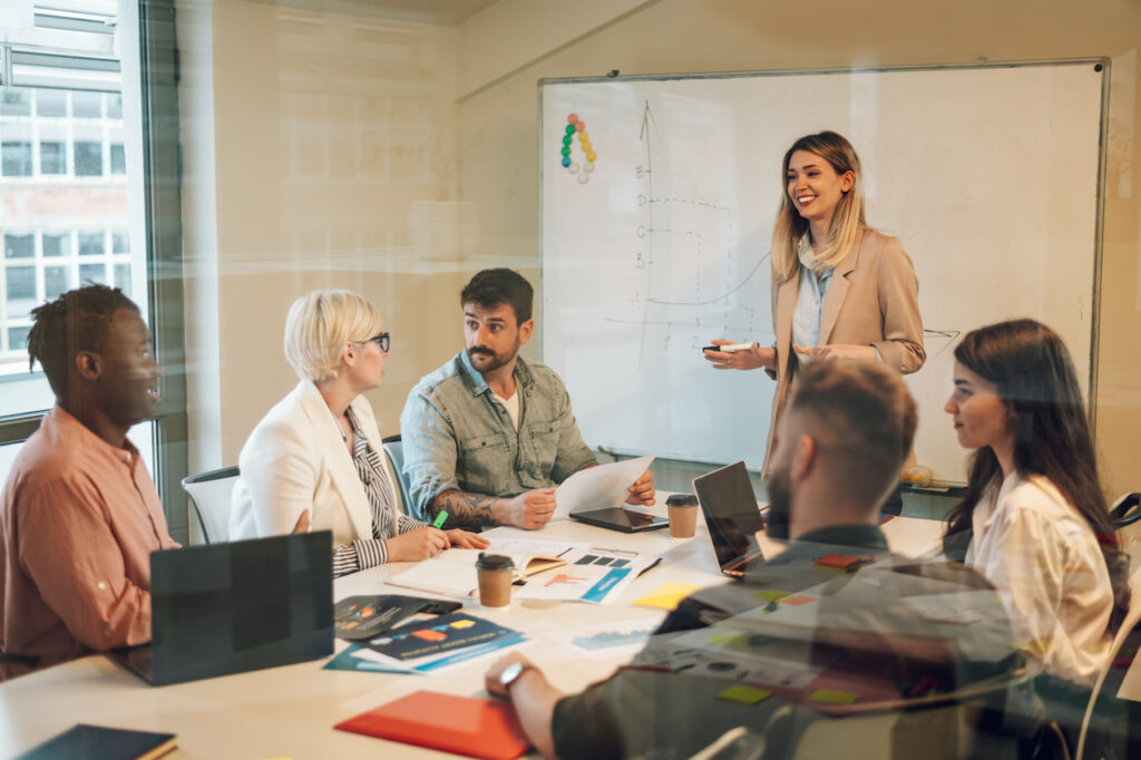 group of coworkers in meeting, discussing business improvement techniques